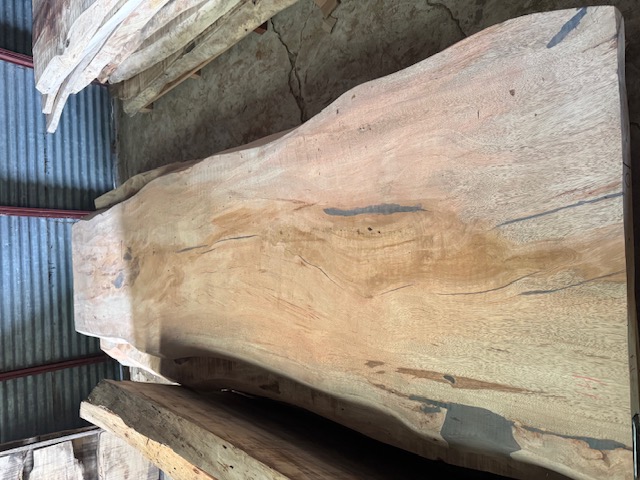 Live-edge purpleheart slab with a natural violet streak