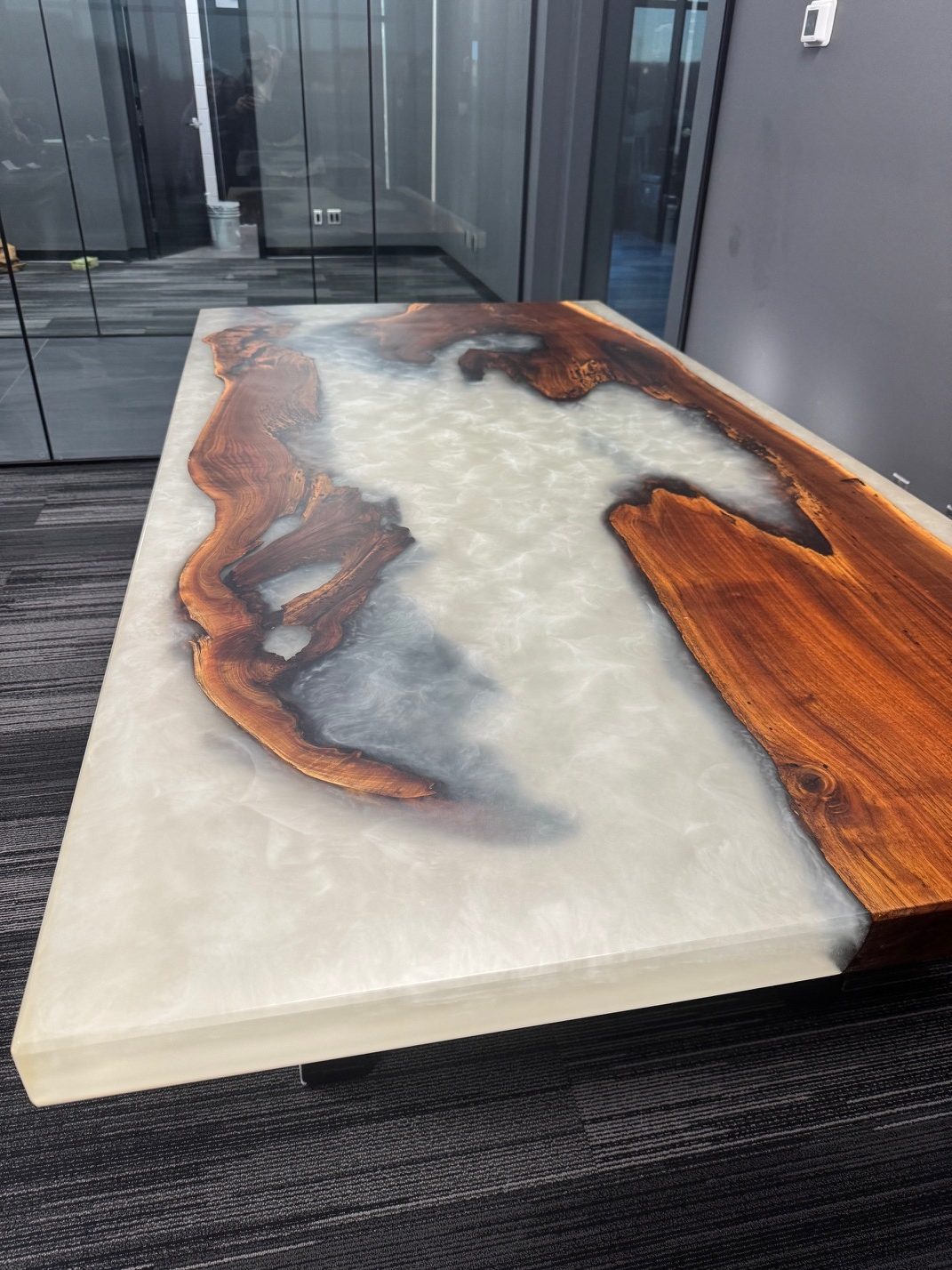 Live-edge dining table with blue-and-white epoxy river and matching benches, by Lost Species