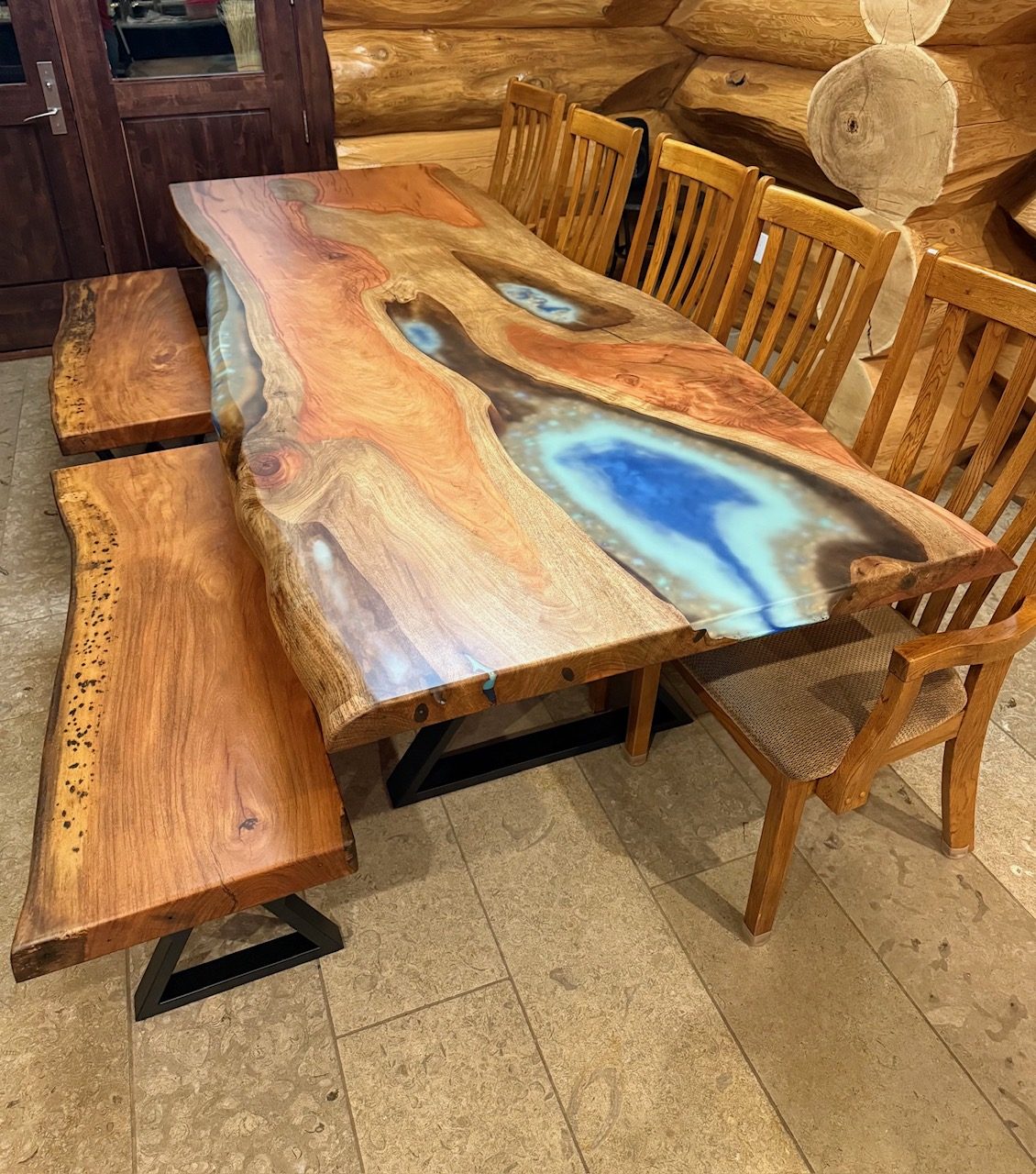 Live-edge dining table with a blue epoxy river down the centre, by Lost Species
