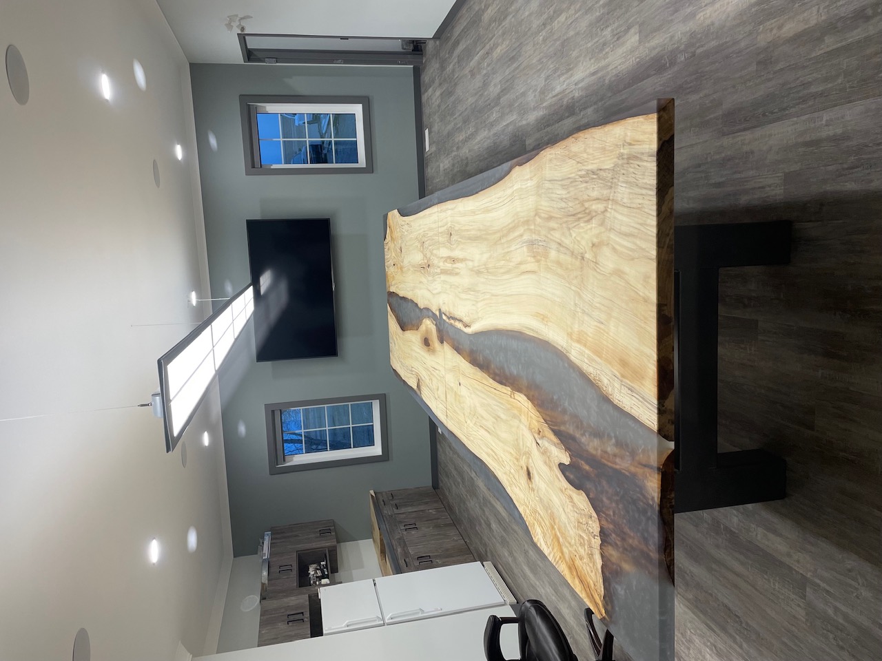 Large live-edge boardroom table in pale hardwood with a dark smoke-grey epoxy river, by Lost Species, Warner Alberta