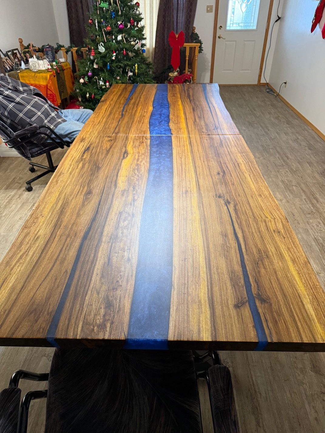 Live-edge tropical hardwood coffee table with a single golden slab top and black steel legs, by Lost Species
